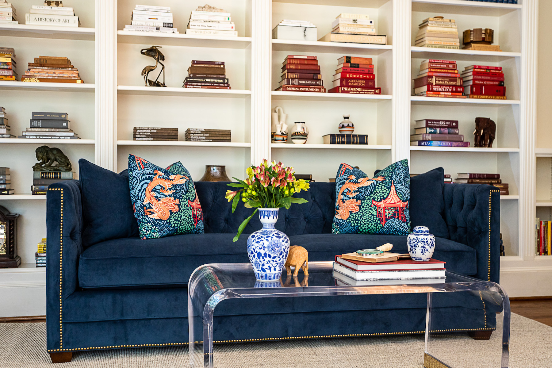 navy-blue-sofa-built-in-bookshelves-living-room-design