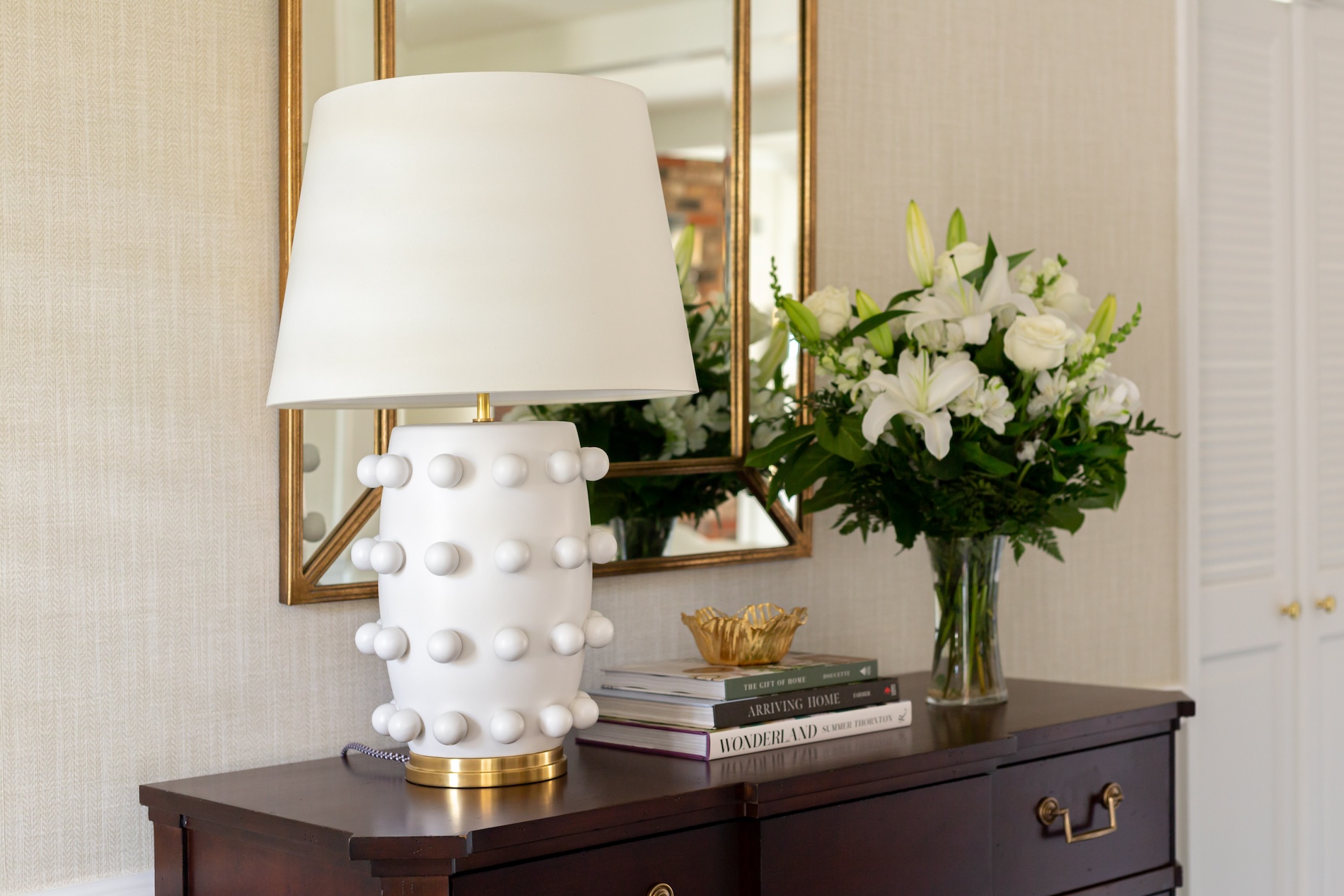 white-lamp-vase-with-flowers-art-books-stacked
